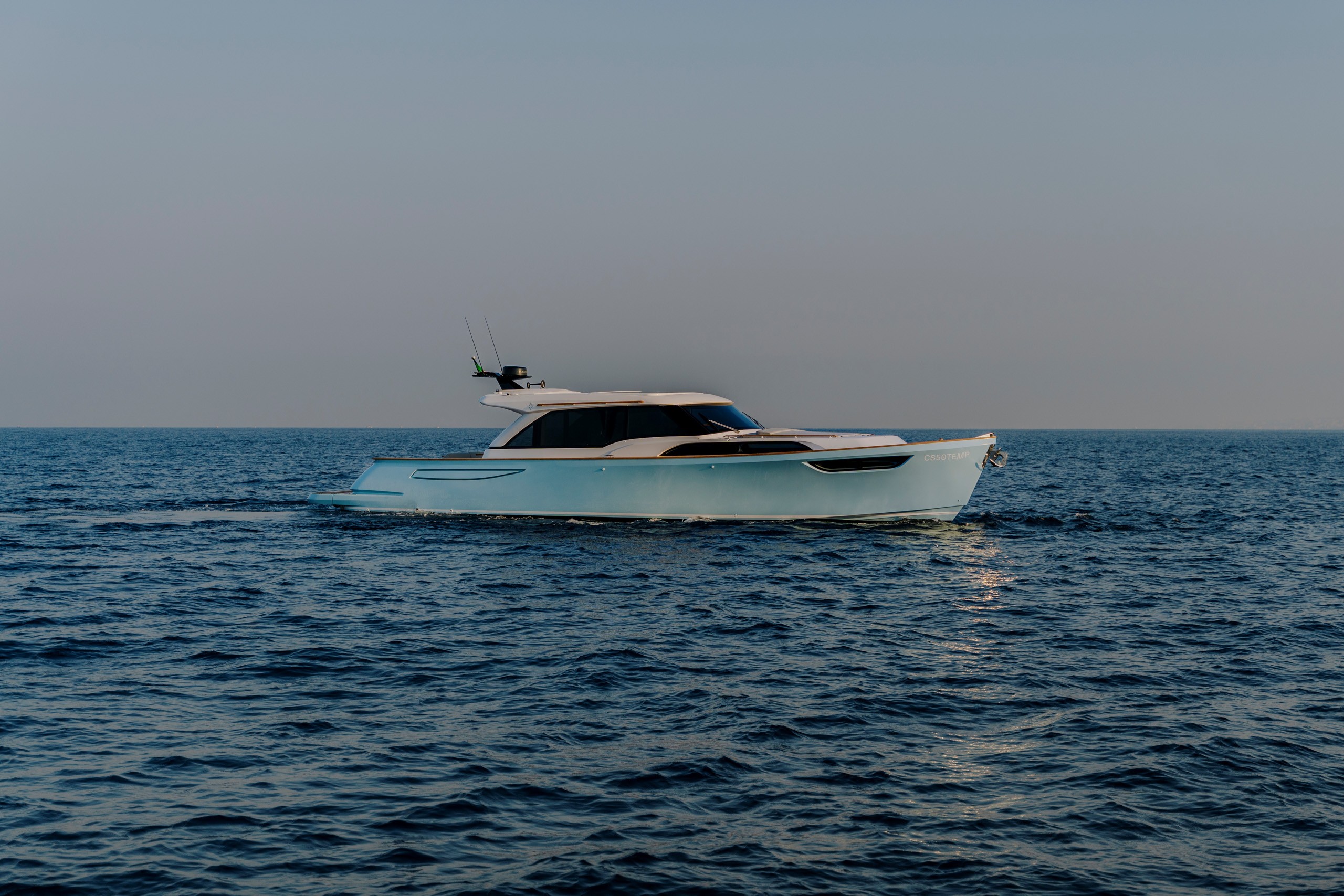 Light blue AD ASTRA 60 luxury lobster boat style motor yacht cruising open blue waters at sea.